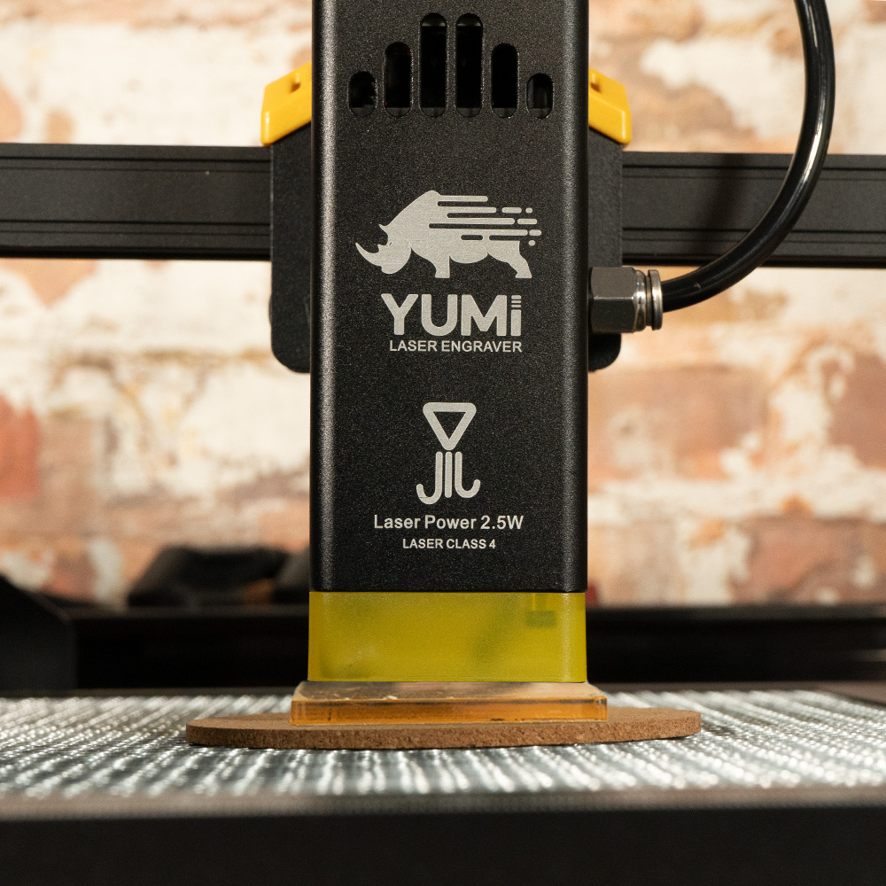 Yumi L-A4 laser head lowered onto the material with the height guide